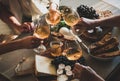 People holding glasses with orange or rose wine over snacks Royalty Free Stock Photo