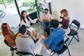 People holding hands while sitting in a circle during group therapy at a mental health center Royalty Free Stock Photo