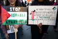 People holding homemade placards at the Free Palestine Rally