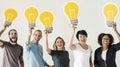 People holding lightbulb icons together Royalty Free Stock Photo