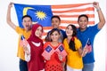 People holding malaysia flag celebrating independence day Royalty Free Stock Photo