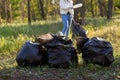 People holding a plastic garbage bottle put in a garbage bag for cleaning Royalty Free Stock Photo