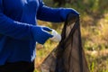 People holding a plastic garbage bottle put in a garbage bag for cleaning Royalty Free Stock Photo