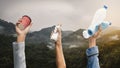 People holding various types of garbage on top of the mountain Royalty Free Stock Photo