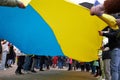 People holding yellow and blue Ukrainian flag at Letna beneficial concert in Prague, Czech Republic