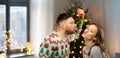 Happy couple kissing under mistletoe on christmas