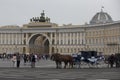 People and a horse chariot with tourists on Palace Square with General Staff Building, Triumphal Arch, Chariot of Glory sculpture Royalty Free Stock Photo