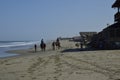 People on horseback are walking along the beach. Mancora, Peru Royalty Free Stock Photo