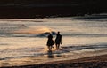 People on horses in the shore at sunset in Spain Royalty Free Stock Photo