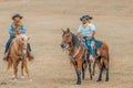 People with horses walk and graze