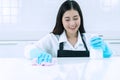 People, housework and housekeeping concept. smile young woman in protective gloves blue wiping dust using spray and Royalty Free Stock Photo