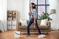 Happy asian woman with mop cleaning floor at home Royalty Free Stock Photo