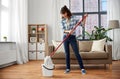 Happy asian woman with mop cleaning floor at home Royalty Free Stock Photo