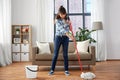 Happy asian woman with mop cleaning floor at home Royalty Free Stock Photo