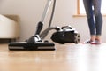 People, housework and housekeeping concept - happy woman with vacuum cleaner at home. Spring cleaning