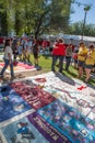 People Hugging Near Section of AIDS Quilt