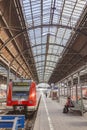 People hurry to the train at historic classicistic train station in Wiesbaden, Germany