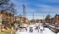 People on the ice in the historic harbor of Dokkum Royalty Free Stock Photo