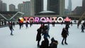 People ice skating on Toronto`s famous ice rink at Nathan Phillips Square