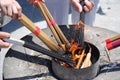 People ignite bundles of incense sticks