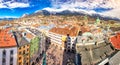 People in Innsbruck city center under Stadtturm tower.