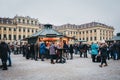 People inside Christmas and New Year`s Market at Schonbrunn Palace, Vienna, Austria.