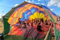 People inside a half inflated hot air balloon