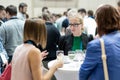 People interacting during coffee break at medical or scientific conference.