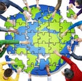 People with Jigsaw Puzzle Forming Globe Royalty Free Stock Photo