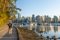People jogging in the Stanley Park Seawall at sunset time. Vancouver, Canada Royalty Free Stock Photo