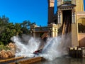 People on the Journey to Atlantis Roller Coaster water ride at SeaWorld speeding around the track and splashing into the water