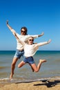 People are jumping against the background of the sea. Royalty Free Stock Photo