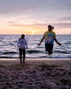 People with jumprope exersise on the beach, couple men and woman exersise together outsied on the beach in the