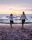 People with jumprope exersise on the beach, couple men and woman exersise together outsied on the beach in the Royalty Free Stock Photo