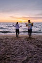 People with jumprope exersise on the beach, couple men and woman exersise together outsied on the beach in the