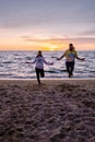 People with jumprope exersise on the beach, couple men and woman exersise together outsied on the beach in the