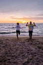 People with jumprope exersise on the beach, couple men and woman exersise together outsied on the beach in the