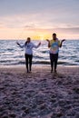 People with jumprope exersise on the beach, couple men and woman exersise together outsied on the beach in the