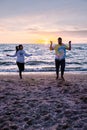 People with jumprope exersise on the beach, couple men and woman exersise together outsied on the beach in the