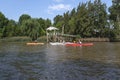 People kayaking along a navigable waterway in the Tigre delta, Argentina