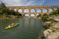 Kayaking under the 2000 year old Roman aqueduct Royalty Free Stock Photo