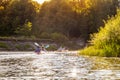 People kayaking on river at sunny summer day