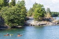 People kayaking in Wanderers Channel, Admiralty group, 1000 islands, Canada Royalty Free Stock Photo