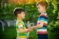 People holding young plant in hands against green spring background. Earth day ecology holiday concept Royalty Free Stock Photo