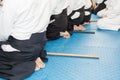 People in kimono on martial arts weapon training seminar