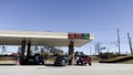 People at Kroger gas prices 2.98 gallon clear blue sky