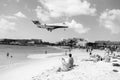 People and landing plane at st.Maarten. Maho beach Royalty Free Stock Photo