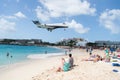 People and landing plane at st.Maarten. Maho beach Royalty Free Stock Photo