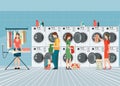 People in laundry room with row of industrial washing machines