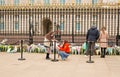 People laying floral tributes infront of Buckingham Palace Royalty Free Stock Photo